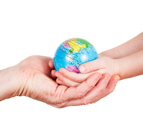 Hands of a child and a man holding a globe