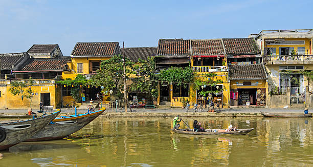 Hoi An, Vietnam View of the colourful harbourside houses and boats reflected in the harbour of the UNESCO World Heritage Site of Hoi An, Vietnam thu bon river stock pictures, royalty-free photos & images