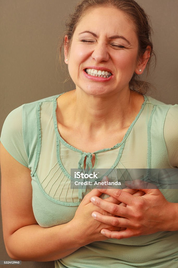 Woman feel pain ache Aches and pains concept. Sick woman having bad ache and pain heart attack health problem. Female placing hands on her chest. Adult Stock Photo