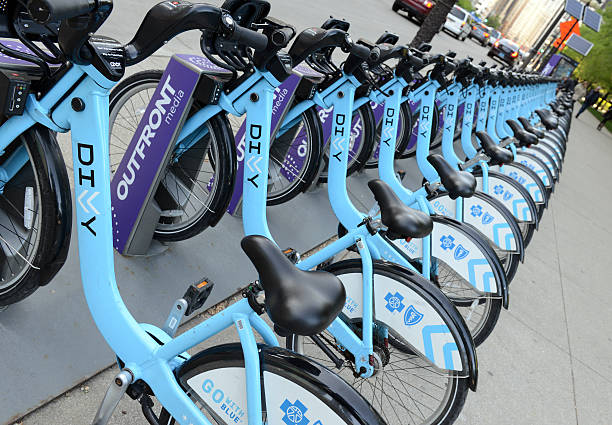 Divvy Bike share, Chicago Chicago, USA - May 19, 2016: Divvy, a Bicycle share program in Chicago gives residents and tourists one more transportation option and reduces the consumption of fossil fuels. chicago smog stock pictures, royalty-free photos & images