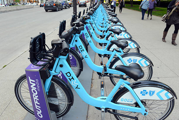 Divvy Bike share, Chicago Chicago, USA - May 19, 2016: Divvy, a Bicycle share program in Chicago gives residents and tourists one more transportation option and reduces the consumption of fossil fuels. chicago smog stock pictures, royalty-free photos & images