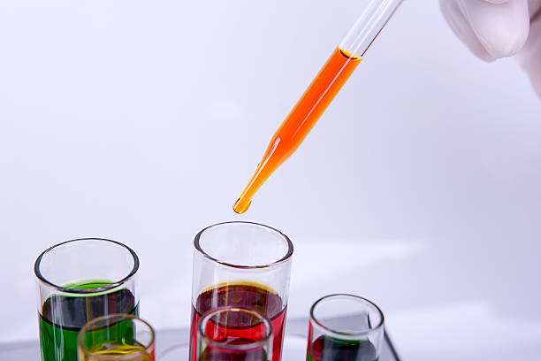 istock Liquid dripping from pipette into test tube 532414548