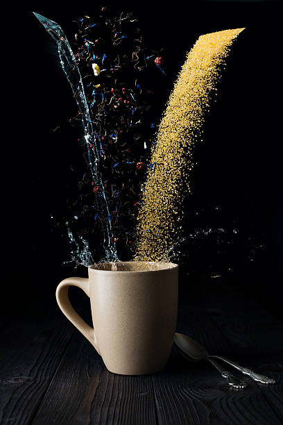 istock dry tea water and sugar pouring into a mug 532415636