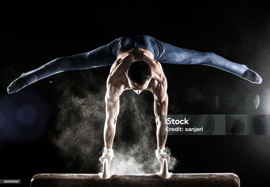 Male Gymnast doing handstand on Pommel Horse Gymnastics Stock Photo