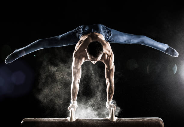 Male Gymnast doing handstand on Pommel Horse Male Gymnast doing handstand on Pommel Horse gymnastics stock pictures, royalty-free photos & images
