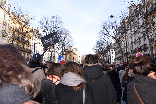 Paris, France - January 11, 2015: demonstration in solidarity with the attack against Charlie Hebdo in Paris, France on 11 January, people holding a sign.