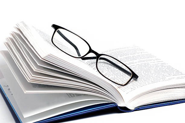 istock book and glasses isolated on white background 532443327