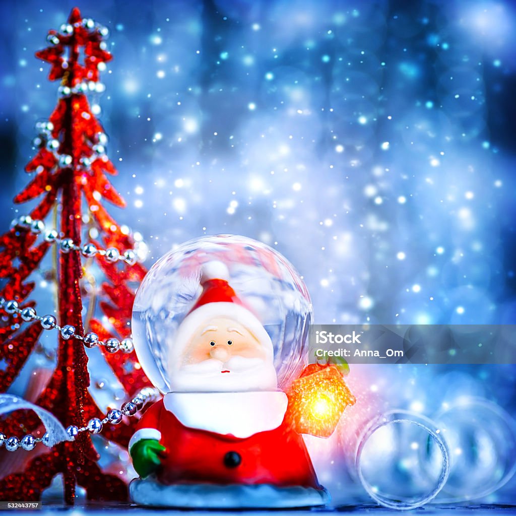 Cute snow globe Santa Blue Christmas background with cute snow globe Santa Claus border over blur bokeh lights, magic of Christmas eve and winter holidays, xmas greeting card Bright Stock Photo