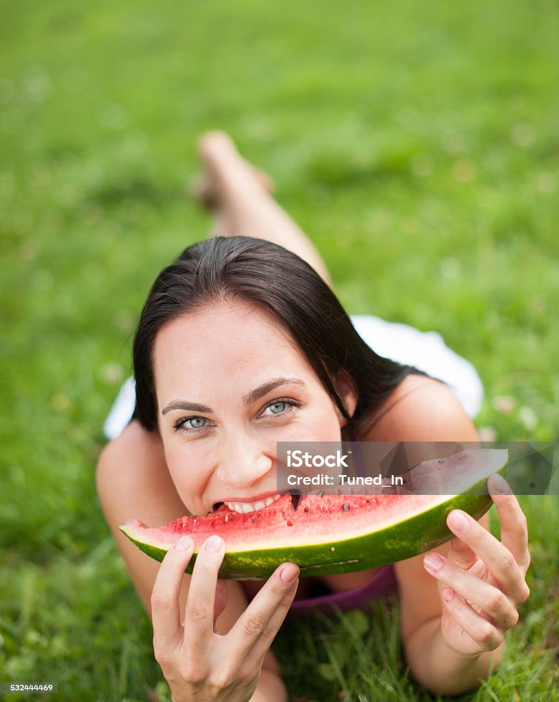 Young woman eating juicy water melon Adult Stock Photo