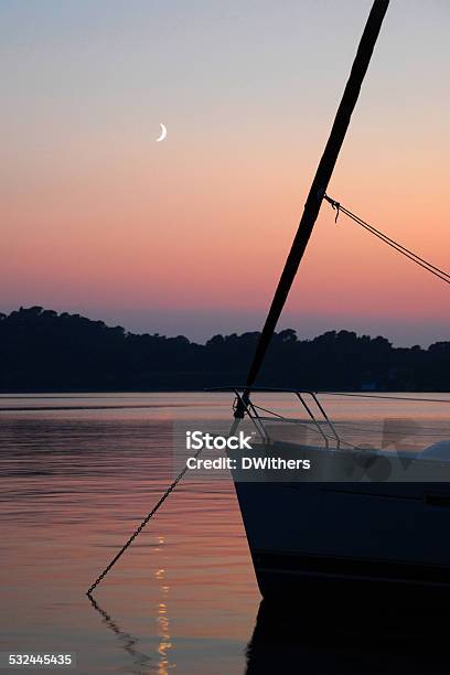 Anchored Yacht At Sunset With Moon Stock Photo - Download Image Now - 2015, Anchor - Vessel Part, Anchor Chain
