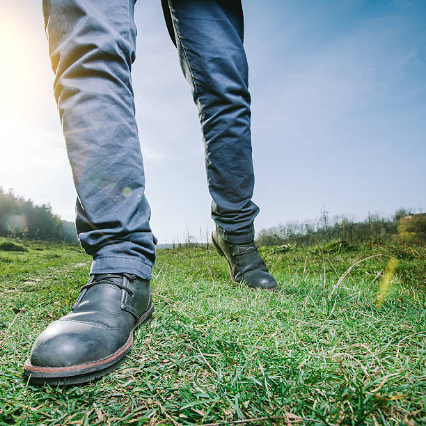 istock man walking on a meadow wearing boots 532445563