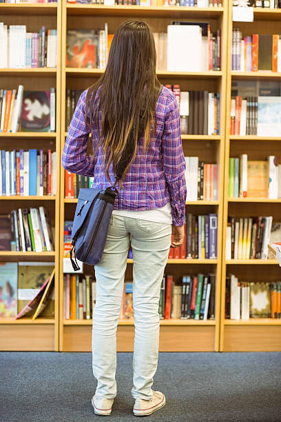istock University student standing in the bookcase 532445865
