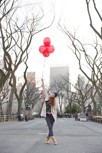istock Young Woman playfully holding balloons 532447301