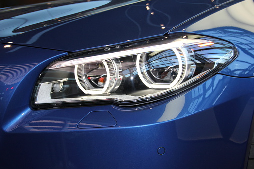 Munich, Germany - February 6, 2014: Headlights of a BMW. The photo was taken at Munich Airport.