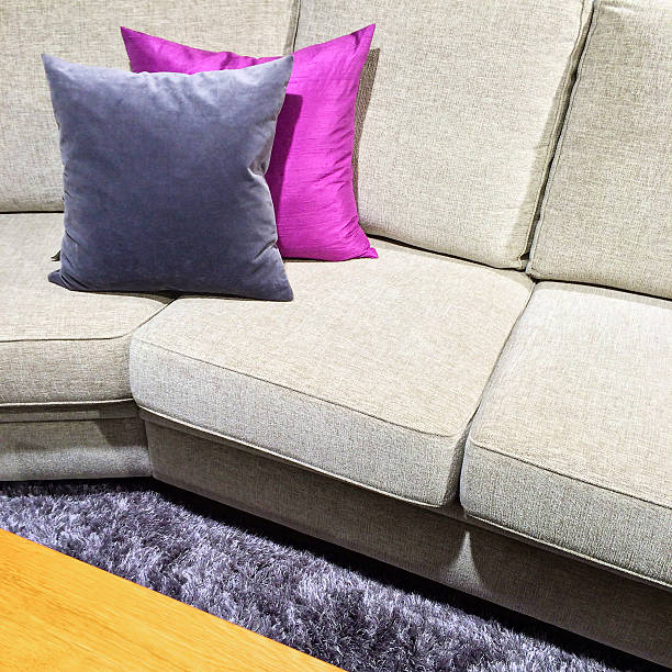 istock Sofa with purple cushions on a fluffy carpet 532450071