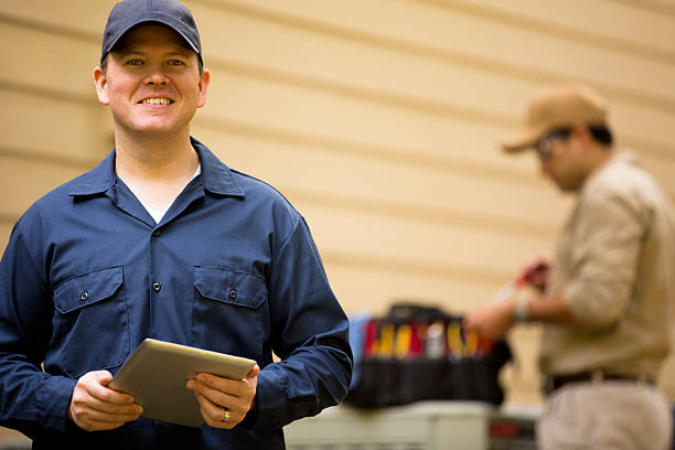 istock Air conditioner repairmen work on home unit. Blue collar workers. 532463773