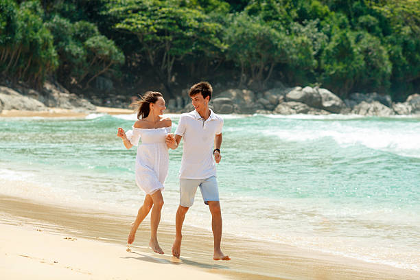 istock happy couple running on tropical beach 532463791