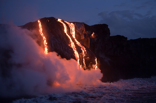 Hot lava stream is flowing into the ocean. Hawaii, Big Island.