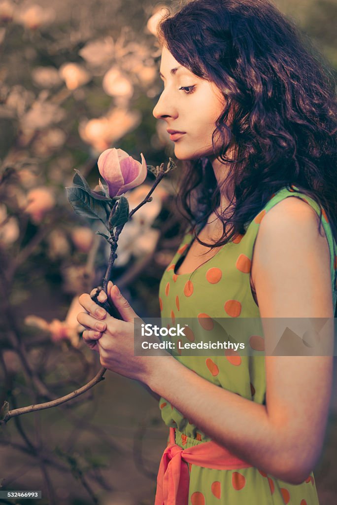 Woman and magnolia Woman on the garden Adult Stock Photo