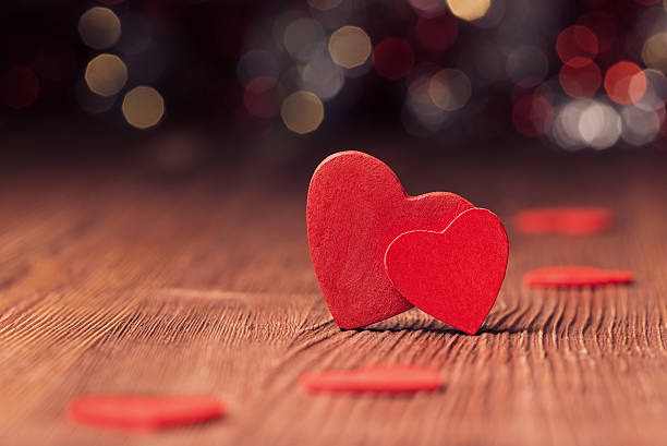 istock Red heart on wooden board against defocused lights 532469069