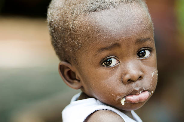 Sadness Despair Depression Symbol: Little African Black Boy Crying Sadly stock photo