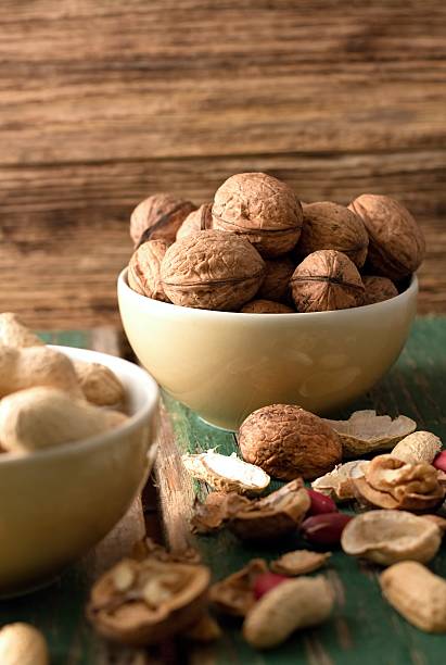 istock Yellow bowl with heap of walnuts 532469845