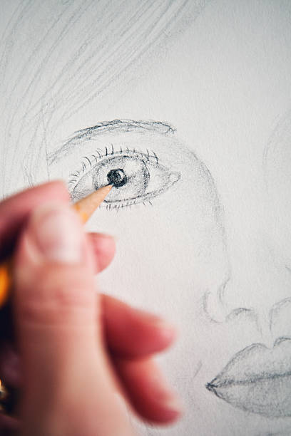istock Woman's Hand Drawing a Female Face 532469901