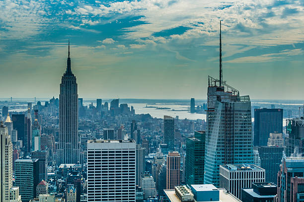 Manhattan New York, United States - September 3, 2008: Manhattan. Elevated view of the southern part of Manhattan. Among the many listed buildings, projecting the image of the Empire State Building. tarde stock pictures, royalty-free photos & images