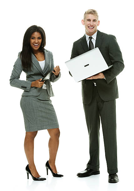 istock Smiling business couple holding tablet & laptop 532470627