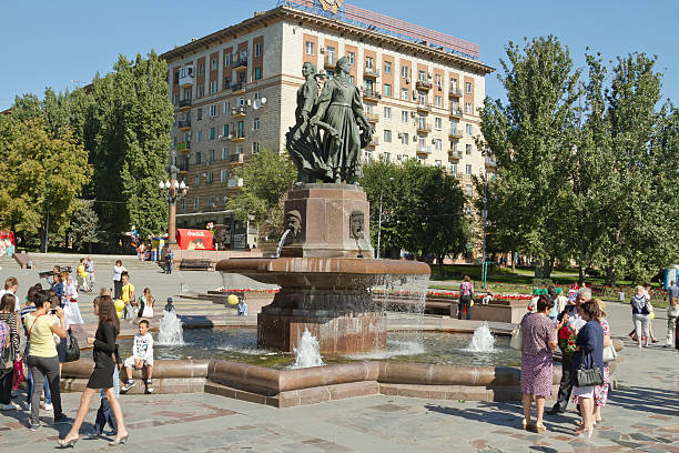 Volgograd, Russia - September 6, 2014: Passers-by walking around the fountain \