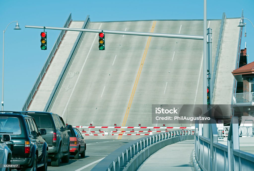 Cars waiting at raised drawbridge over river in Seattle WA Drawbridge Stock Photo