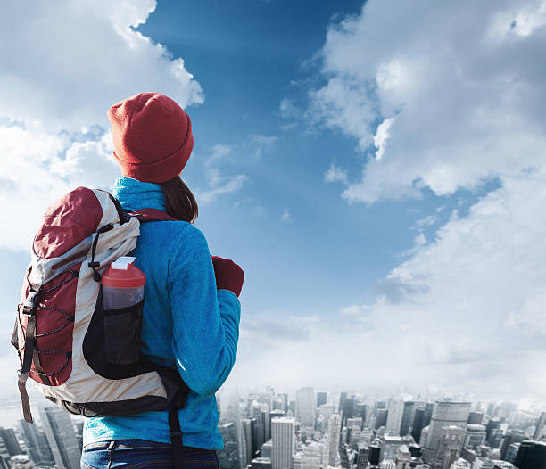 istock Hiker standing and looking into the city landscape 532482669