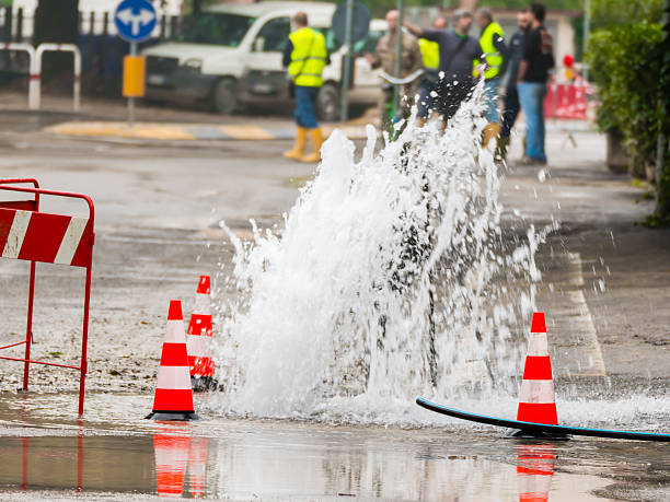 istock road spurt water beside traffic cones 532483351