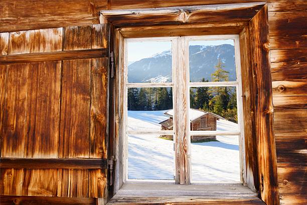 Ski hut in the wooden window as a background image