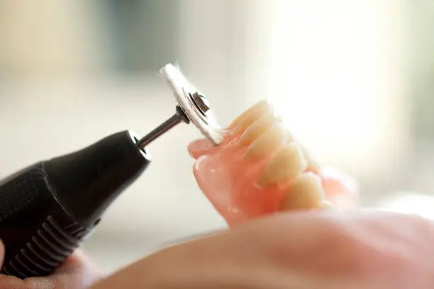 Dental technician  working in dental laboratory