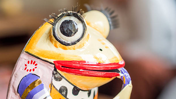istock closeup view of ceramic multicolored frog playing saxophone 532486663
