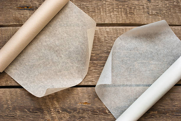 istock Two open rolls of paper on the wooden table background 532486693