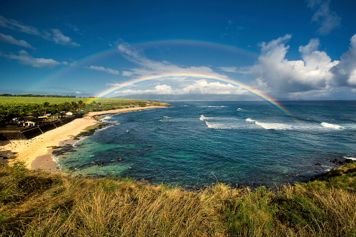 Rainbow over Ho'okipa Beach Park, famous surf spot on the north shore of Maui, Hawaii