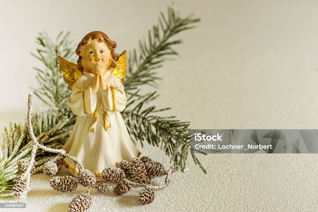 angel Christmas decorations, clay angel with cones and snow on a white background. Angel Stock Photo