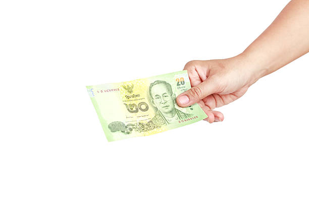 istock Hand holding Thai money isolated on white background 532487935