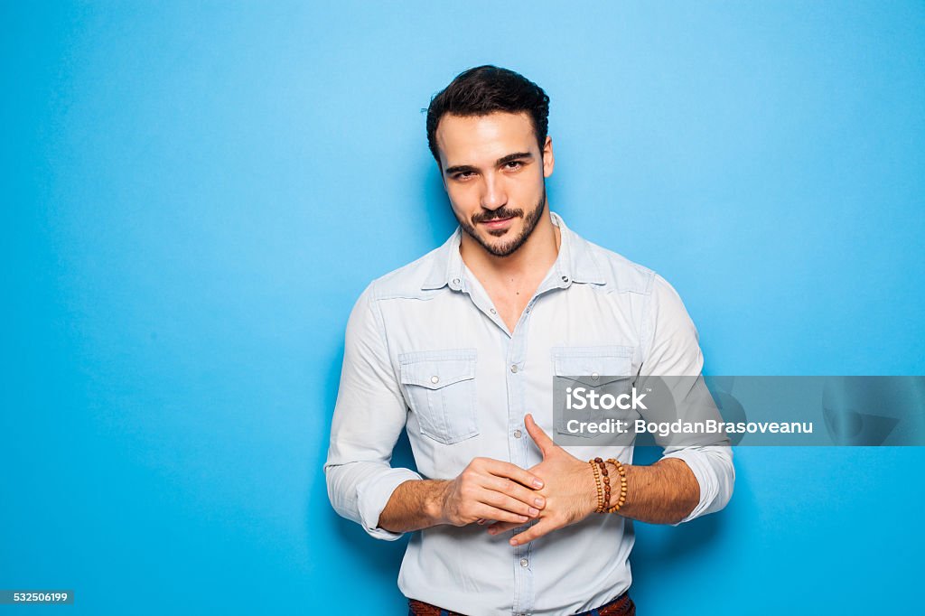 Handsome adult and masculine man on a blue background sexy and confident handsome man on a blue background Adult Stock Photo