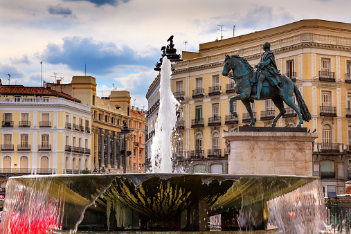 Puerta del Sol Gate of the Sun Most Famous Square Fountain King Carlos III Equestrian Statue in Madrid Spain King of Spain in the 1700s.  Replica of statue created in 1700s by Juan Pascal de de Mena