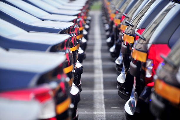 New cars in line Outdoor detail shot with lot of brand new cars in a row automobile industry stock pictures, royalty-free photos & images