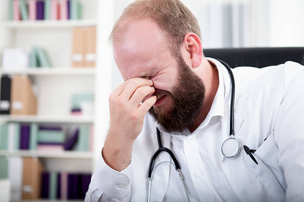 istock Doctor is overworked and sits at his desk in his practice 532516547