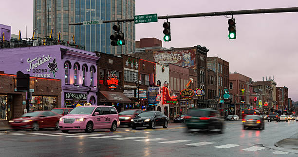 Broadway Street in Nashville Nashville, Tennessee, USA - December 1, 2014: Rainy evening on Broadway Street in downtown Nashville tennessee road sign stock pictures, royalty-free photos & images