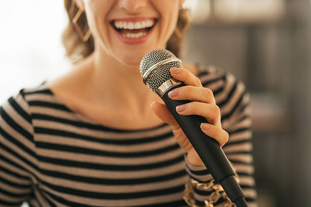 istock closeup on young woman singing with microphone in loft apartment 532517355