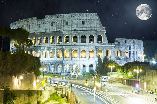 istock Colosseum at night, Rome, Italy with huge Moon 532517783