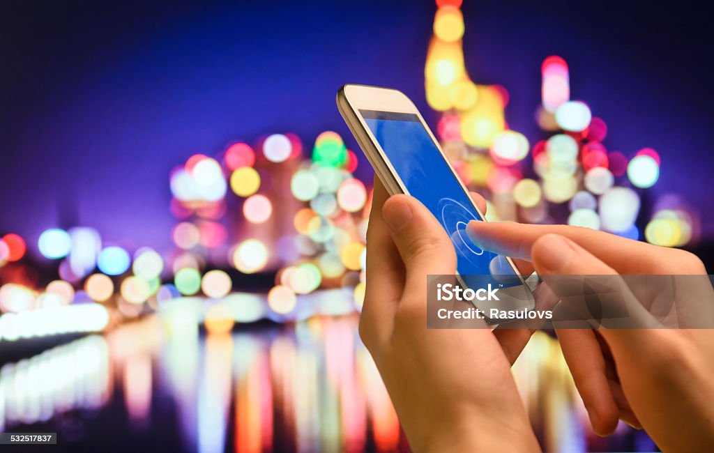 Man hands holding smartphone. Man with modern mobile phone in hands touching on a  screen.  2015 Stock Photo