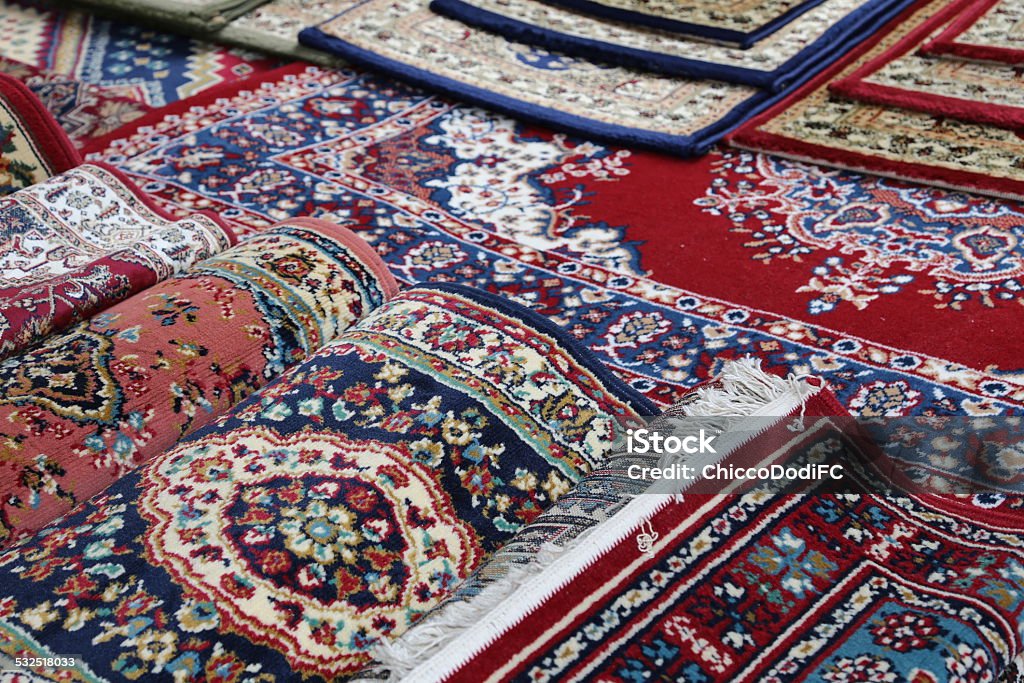 many colourful oriental carpets for sale many colourful Oriental rugs for sale in the shop of rugs 2015 Stock Photo