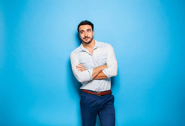 Handsome adult and masculine man on a blue background stock photo